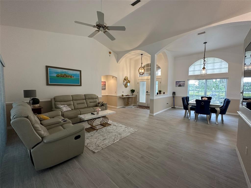 1238 Yorkshire Street Port Charlotte, FL 33952 - Photo 7 of 40 a living room with furniture dining area and a chandelier
