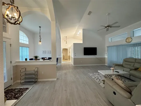 a living room with furniture and a flat screen tv