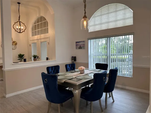 a view of a dining room with furniture wooden floor and chandelier