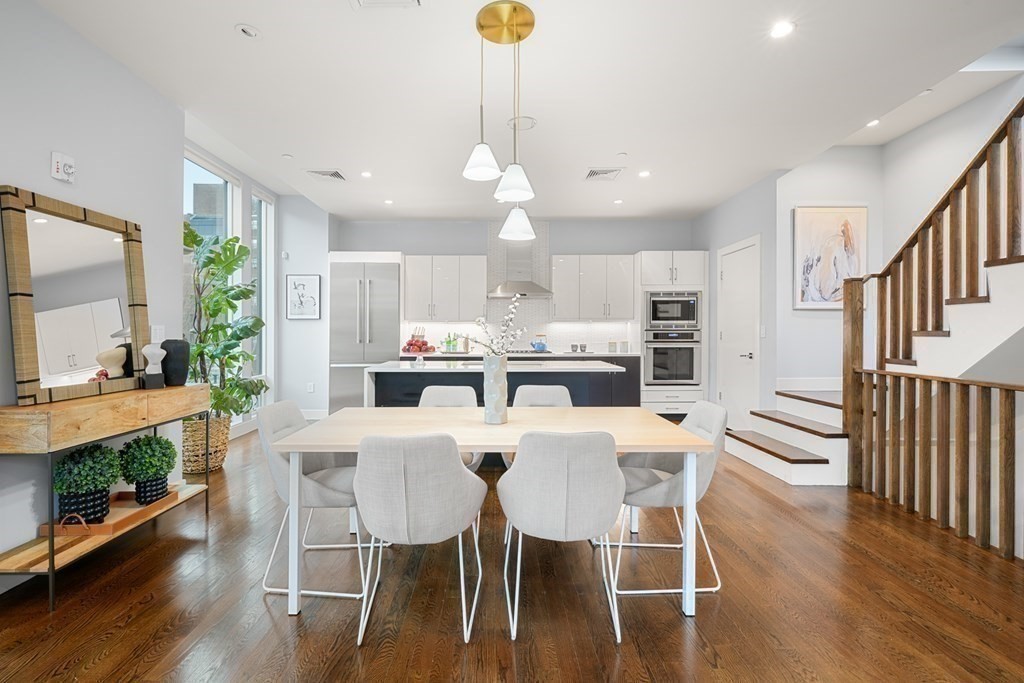 a view of a dining room with furniture window and wooden floor