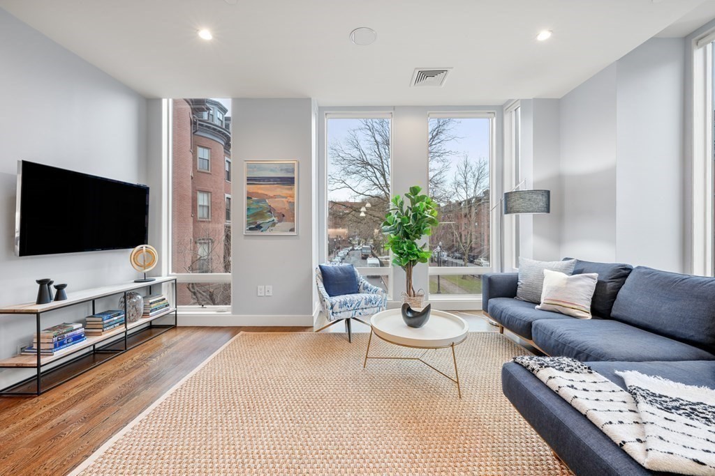 1672 R Washington Street, Unit TH1 Boston, MA 02118 - Photo 11 of 40 a living room with furniture and a flat screen tv