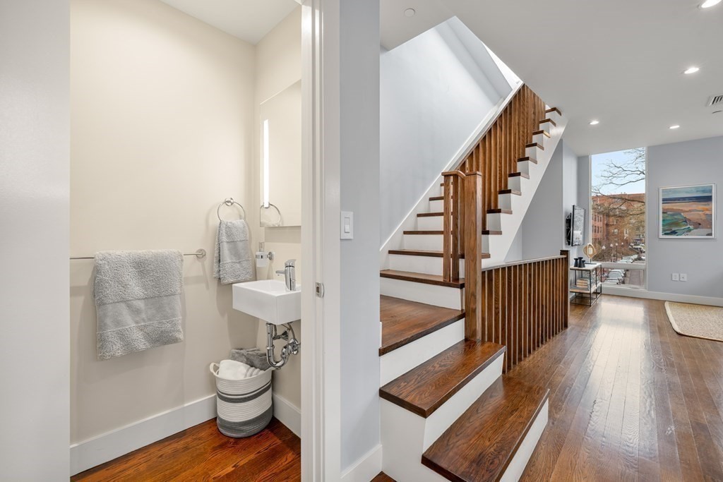 1672 R Washington Street, Unit TH1 Boston, MA 02118 - Photo 12 of 40 a bathroom with a toilet and a shower curtain