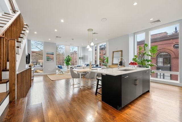 a large kitchen with lots of counter top space and wooden floor