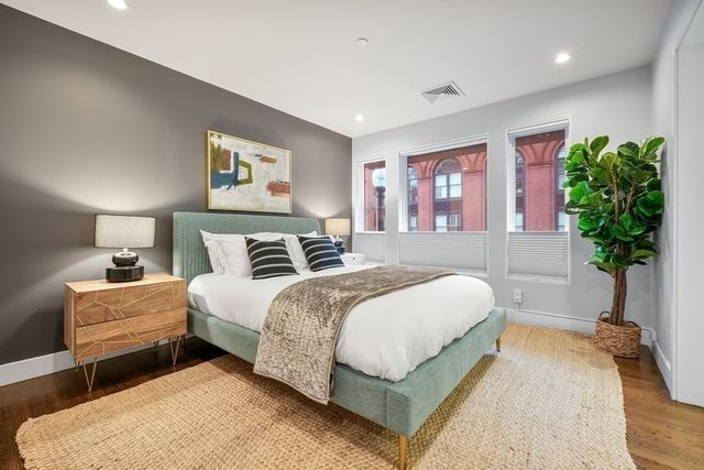 a bedroom with bed and a potted plant