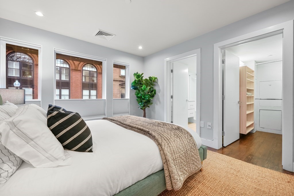 1672 R Washington Street, Unit TH1 Boston, MA 02118 - Photo 18 of 40 a spacious bedroom with a bed and a couch