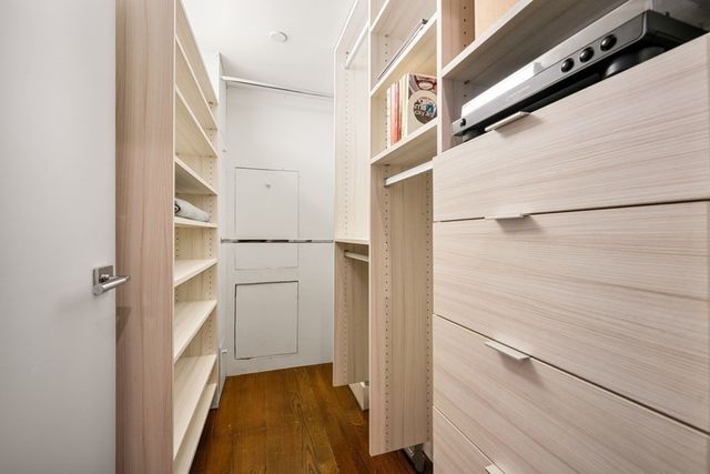 a view of walk in closet with white walls