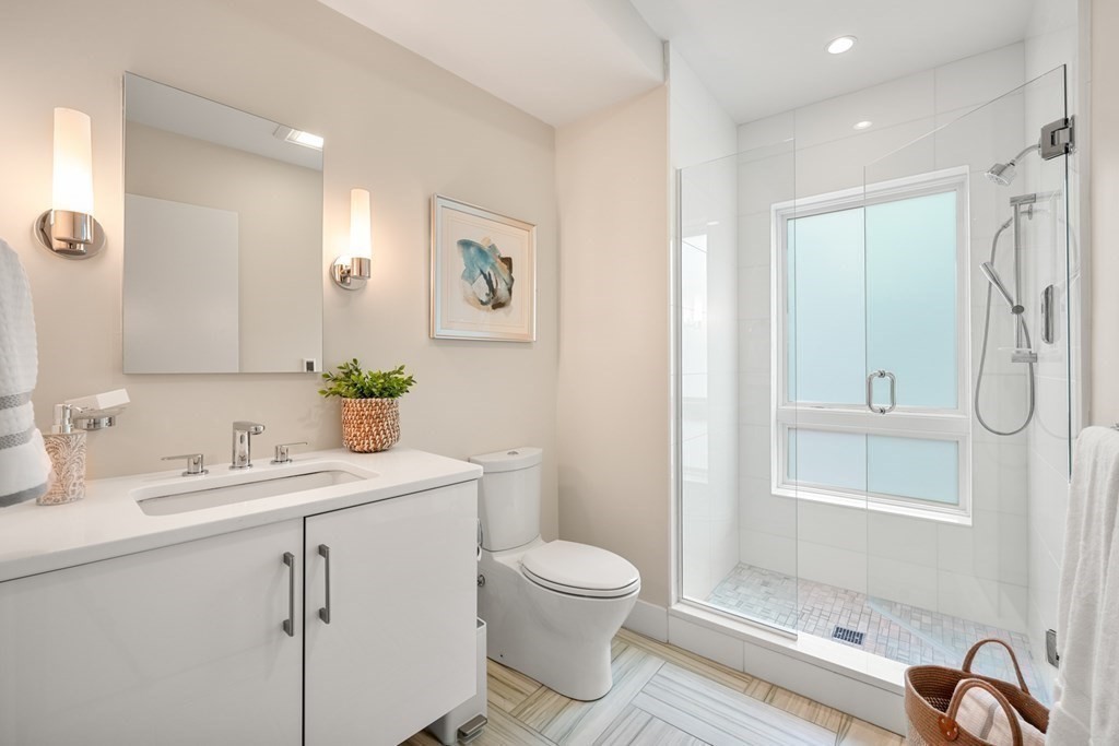 1672 R Washington Street, Unit TH1 Boston, MA 02118 - Photo 22 of 40 a bathroom with a granite countertop sink toilet and shower