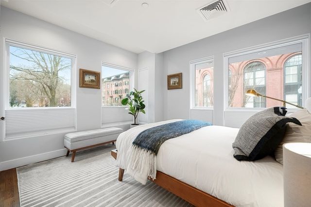 a bedroom with a bed and a large window