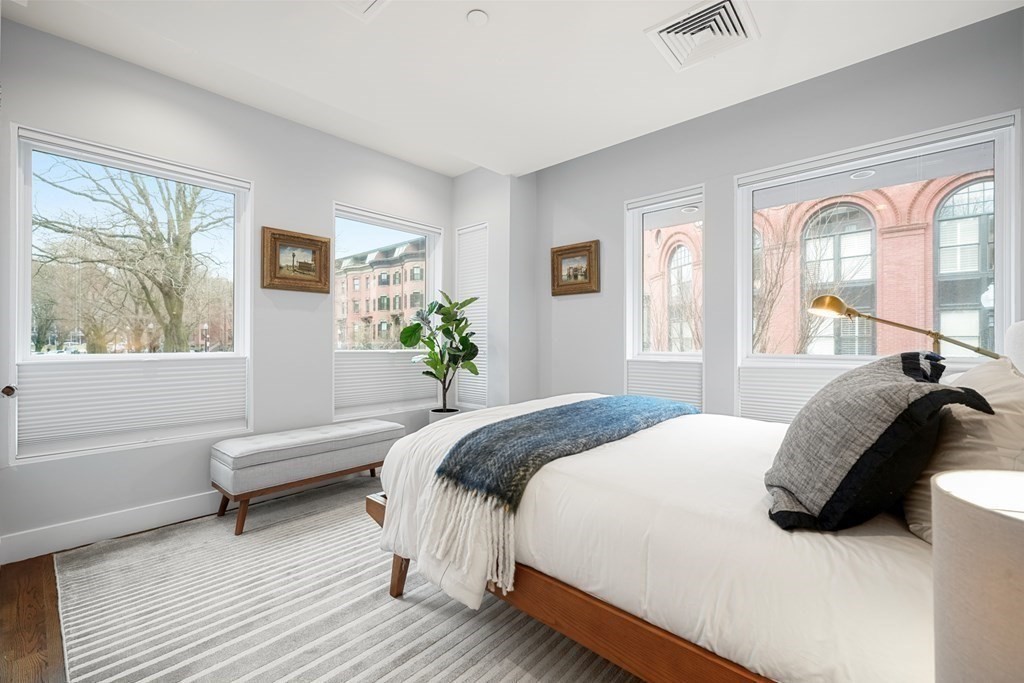 1672 R Washington Street, Unit TH1 Boston, MA 02118 - Photo 24 of 40 a bedroom with a bed and a large window