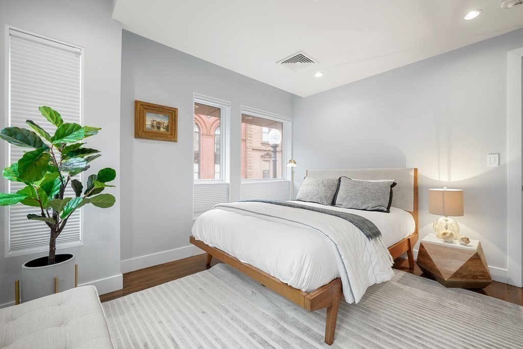 1672 R Washington Street, Unit TH1 Boston, MA 02118 - Photo 25 of 40 a bedroom with a bed table and a window