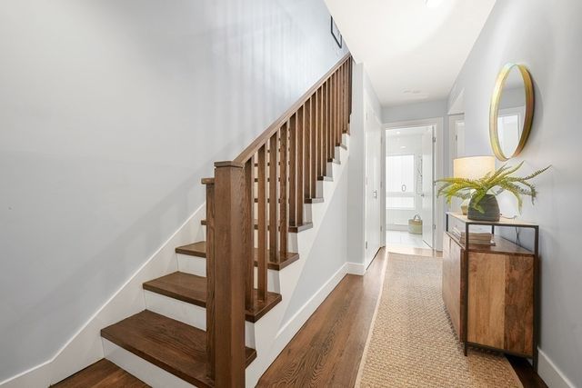a view of entryway and hall with wooden floor