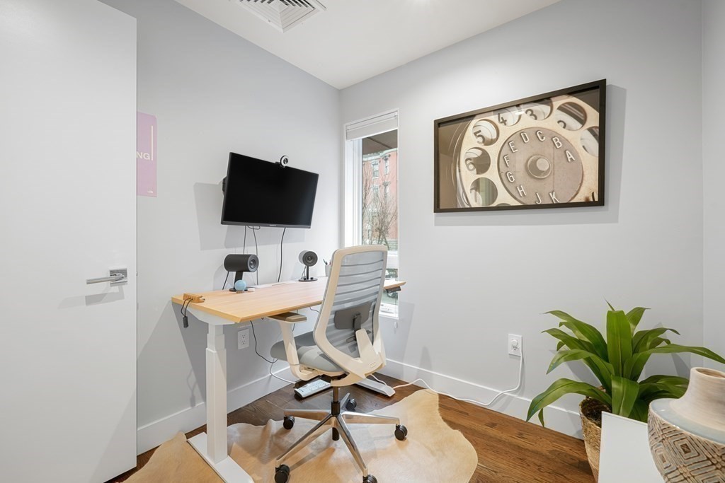 1672 R Washington Street, Unit TH1 Boston, MA 02118 - Photo 29 of 40 a view of a workspace with furniture and a potted plant