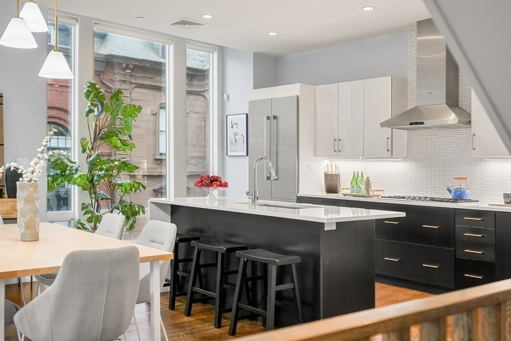 1672 R Washington Street, Unit TH1 Boston, MA 02118 - Photo 3 of 40 a kitchen with a table and chairs in it