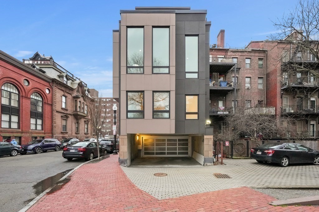 1672 R Washington Street, Unit TH1 Boston, MA 02118 - Photo 32 of 40 a view of a street that has couple of cars parked on the road