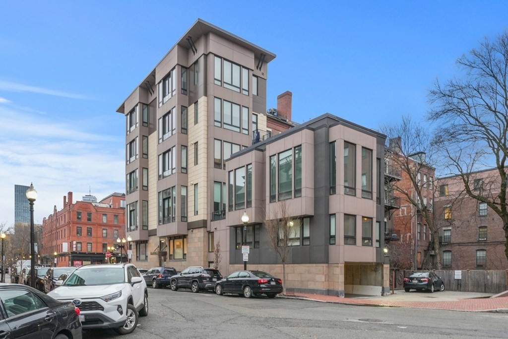 1672 R Washington Street, Unit TH1 Boston, MA 02118 - Photo 40 of 40 a city street lined with parked cars and buildings