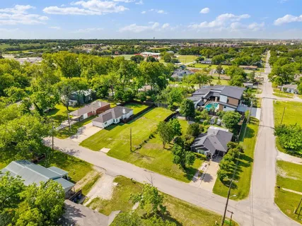 an aerial view of residential houses with outdoor space and swimming pool