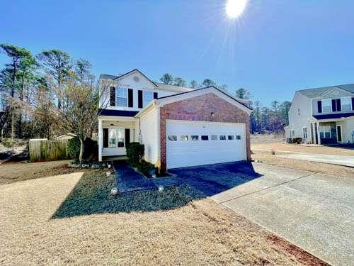 a front view of a house with a yard