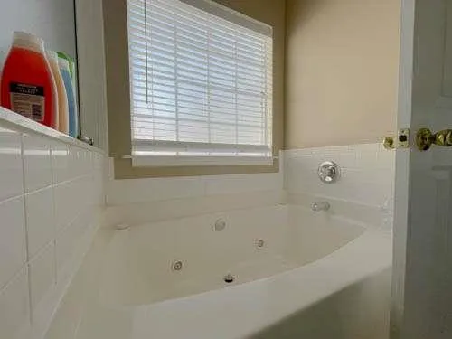 a white bath tub sitting next to a window