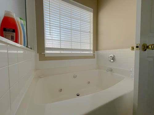 147 Benfield Circle Southeast Cartersville, GA 30121 - Photo 11 of 18 a white bath tub sitting next to a window