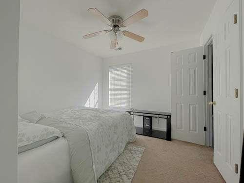 147 Benfield Circle Southeast Cartersville, GA 30121 - Photo 12 of 18 a spacious bedroom with a bed and a chandelier