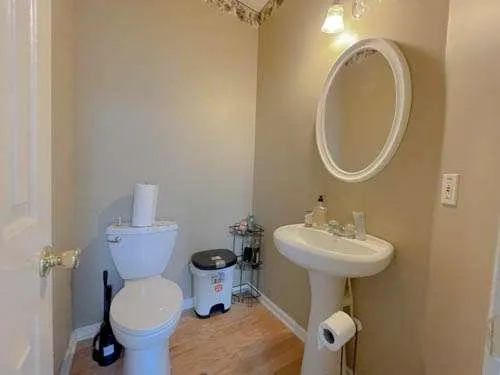 a bathroom with a sink toilet and a mirror