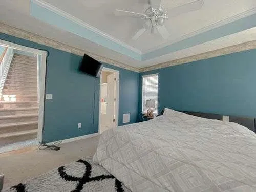 a bedroom with a bed and a chandelier