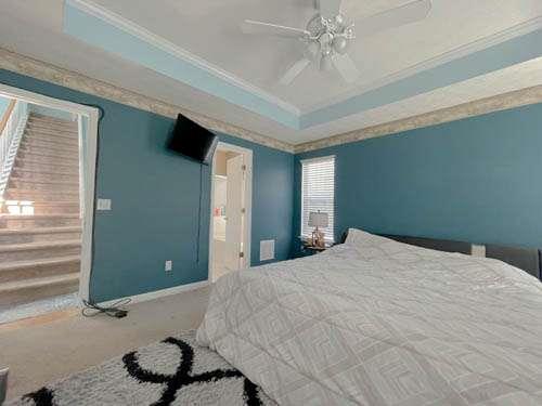 147 Benfield Circle Southeast Cartersville, GA 30121 - Photo 9 of 18 a bedroom with a bed and a chandelier