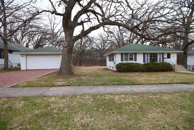1460 Burr Oak Road Homewood, IL 60430 - Photo 2 of 19 a front view of a house with a yard and trees