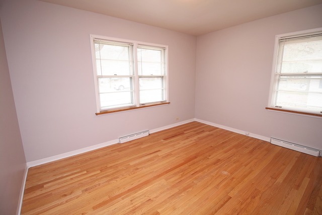 1460 Burr Oak Road Homewood, IL 60430 - Photo 11 of 19 an empty room with wooden floor and windows