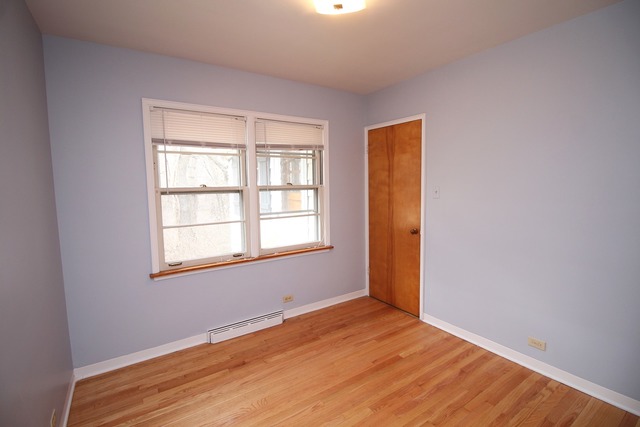 1460 Burr Oak Road Homewood, IL 60430 - Photo 13 of 19 an empty room with wooden floor and windows