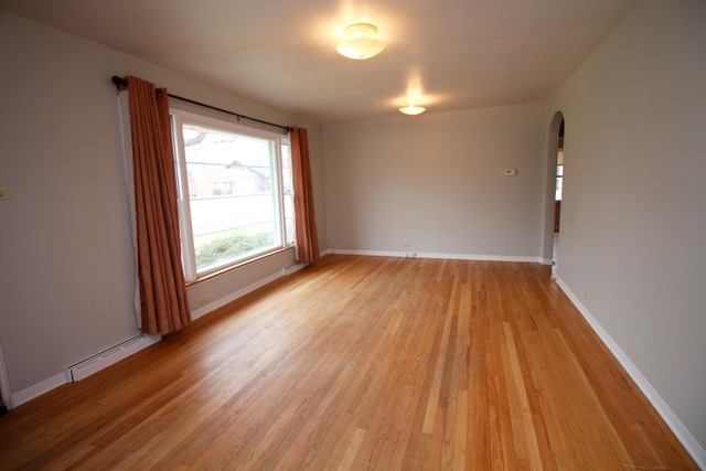 1460 Burr Oak Road Homewood, IL 60430 - Photo 4 of 19 an empty room with wooden floor and windows