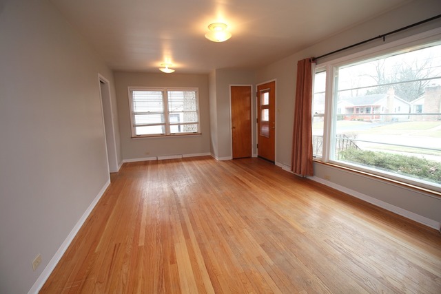 1460 Burr Oak Road Homewood, IL 60430 - Photo 5 of 19 a view of empty room with wooden floor and fan
