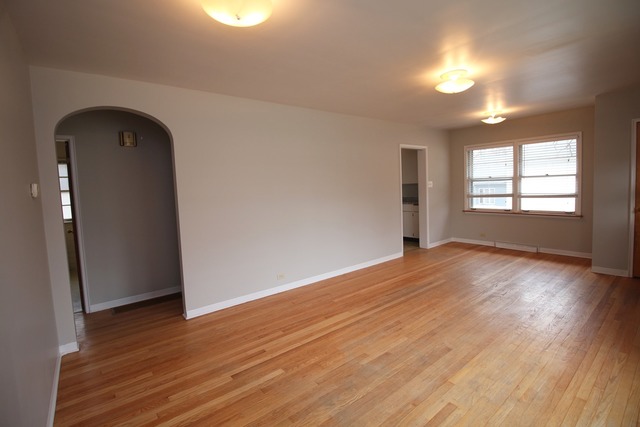 1460 Burr Oak Road Homewood, IL 60430 - Photo 6 of 19 an empty room with wooden floor and windows