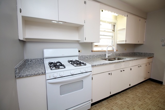 1460 Burr Oak Road Homewood, IL 60430 - Photo 7 of 19 a kitchen with granite countertop white cabinets and white appliances