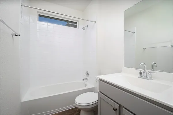 a bathroom with a sink a toilet and a shower