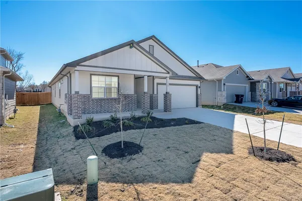 a front view of a house with garden