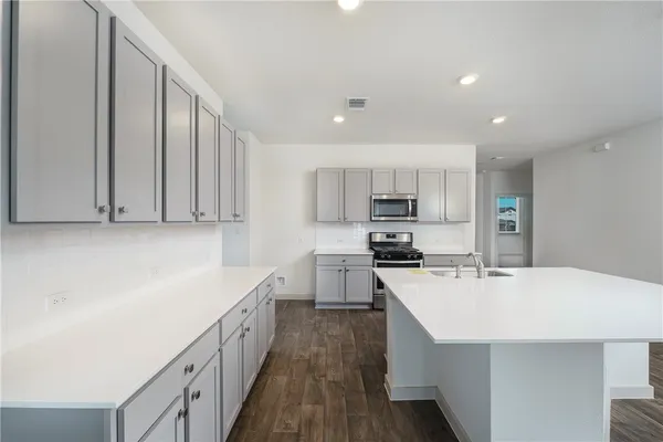 a kitchen with stainless steel appliances a sink stove and refrigerator