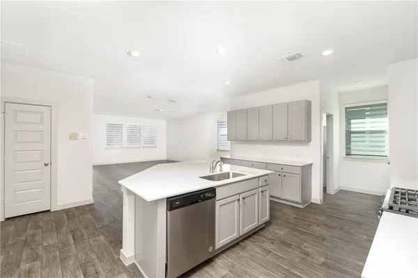a kitchen with a sink stove and cabinets