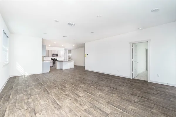 a view of kitchen and empty room