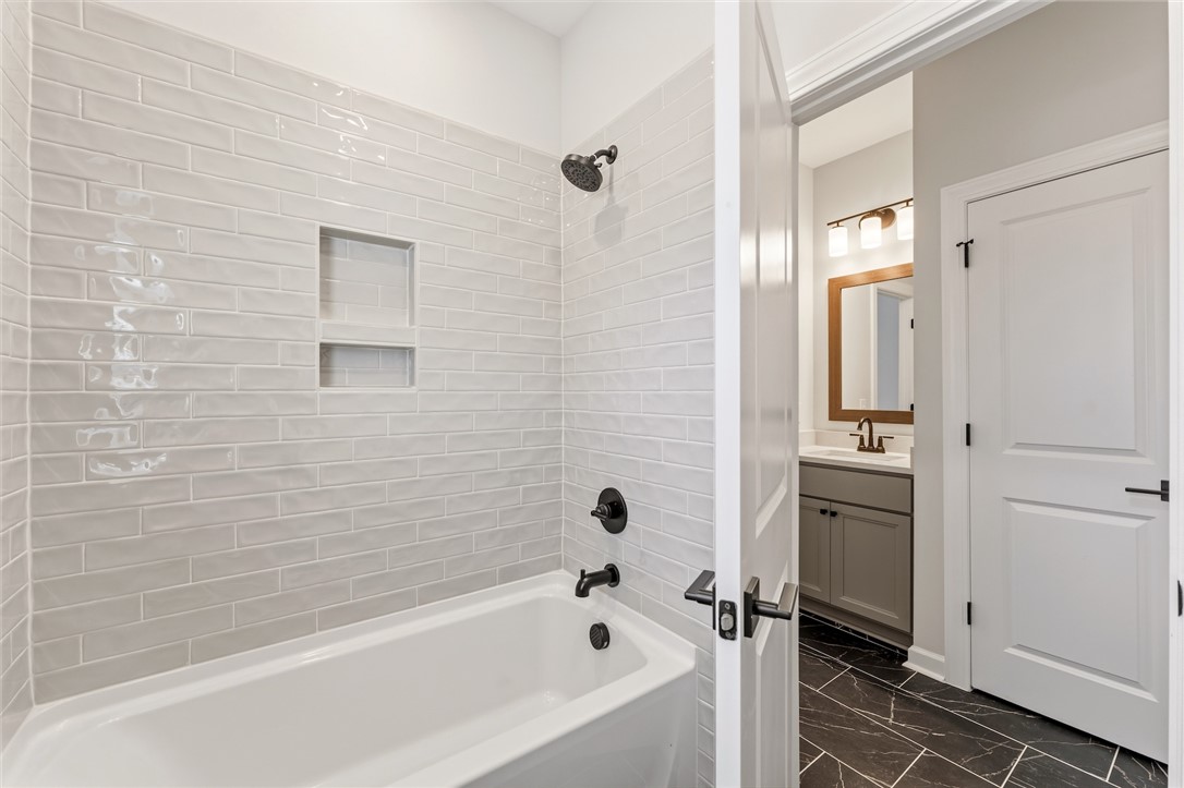701 Weathered Oak Way Anderson, SC 29621 - Photo 31 of 41 This bathroom features sleek tile flooring, a shower-and-tub combination, and a modern vanity.