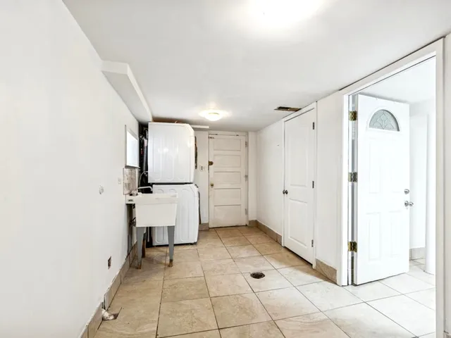 a view of a kitchen with white cabinets and entryway