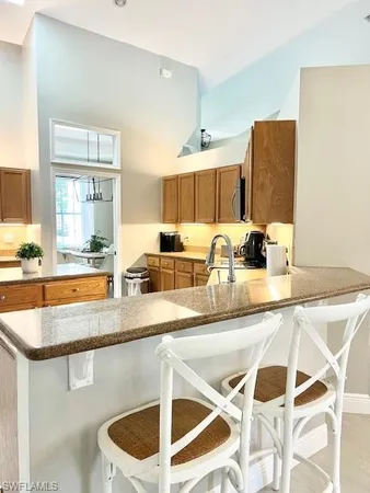 a kitchen with stainless steel appliances granite countertop a sink and a refrigerator