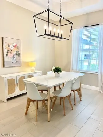 a view of a dining room with furniture and window