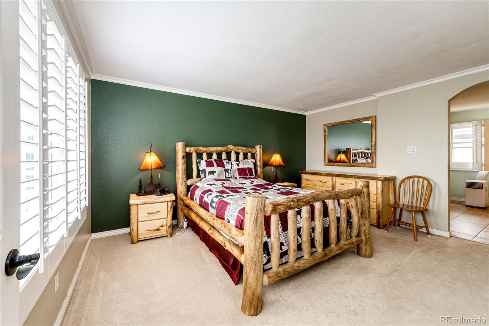 2218 Deerpath Road Franktown, CO 80116 - Photo 19 of 46 a bed sitting in a bedroom next to a window