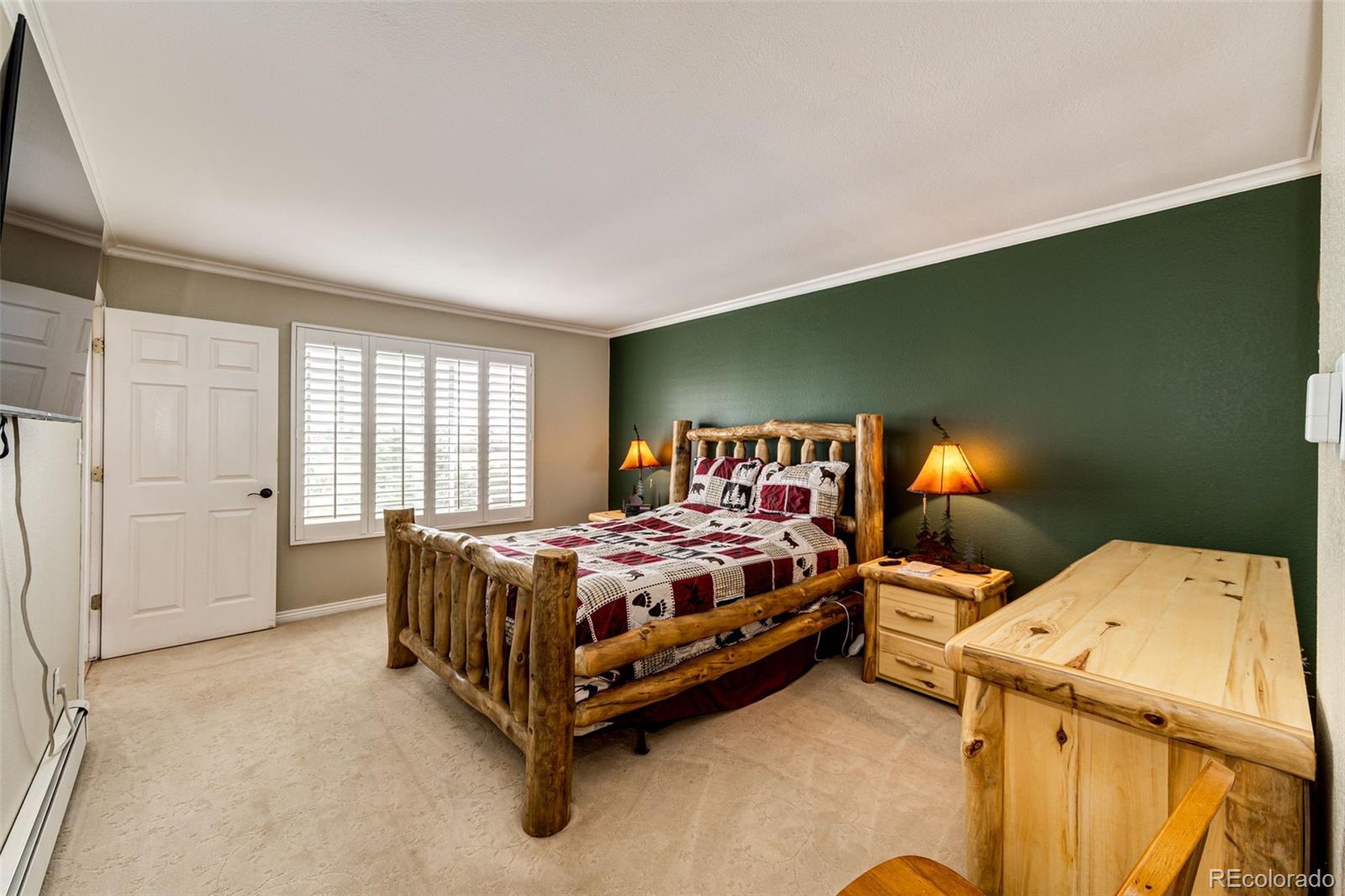 2218 Deerpath Road Franktown, CO 80116 - Photo 20 of 46 a bed sitting in a bedroom next to a window