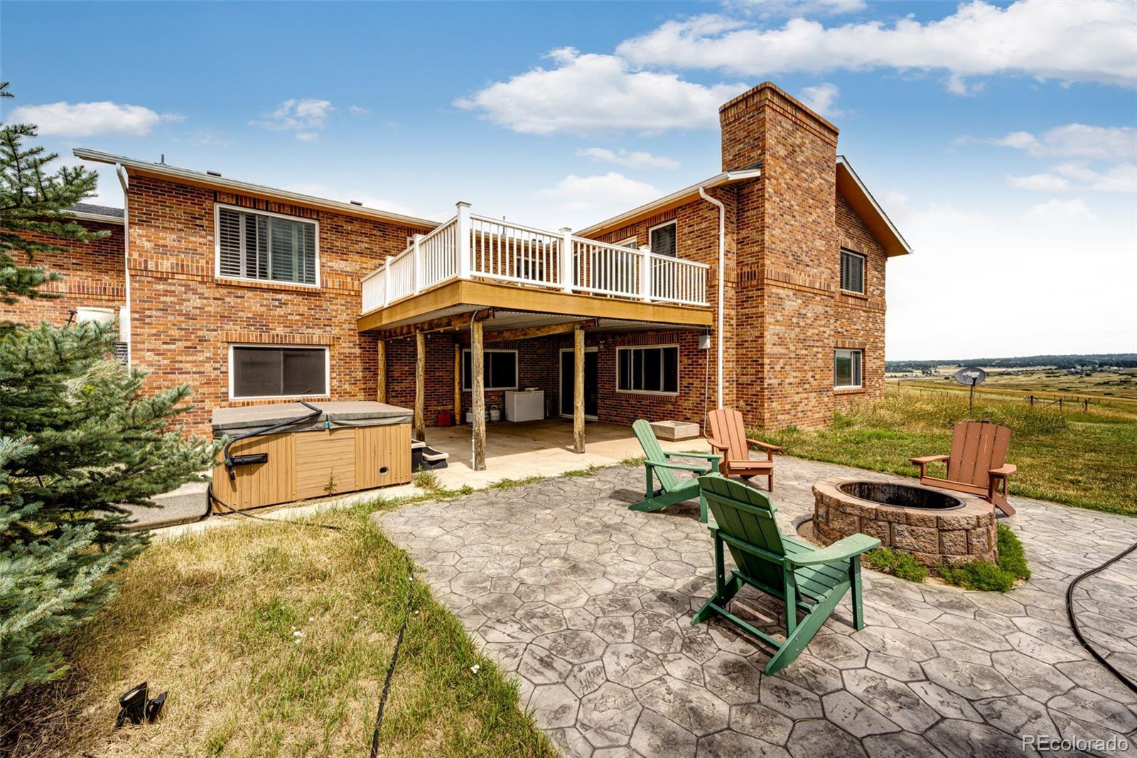 2218 Deerpath Road Franktown, CO 80116 - Photo 41 of 46 a view of a house with backyard sitting area and garden