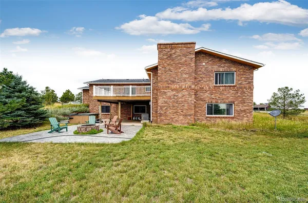 a backyard of a house with table and chairs
