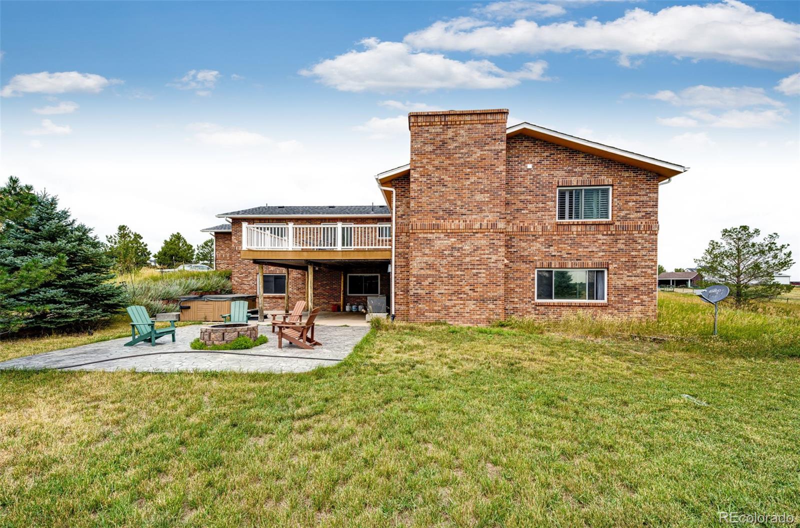 2218 Deerpath Road Franktown, CO 80116 - Photo 42 of 46 a backyard of a house with table and chairs