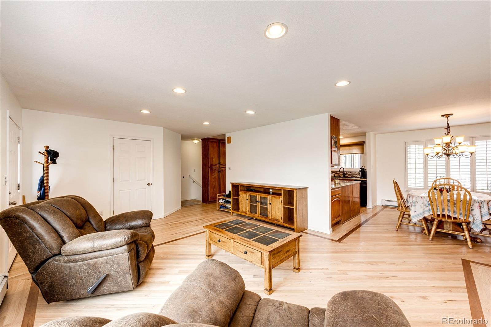2218 Deerpath Road Franktown, CO 80116 - Photo 9 of 46 a living room with furniture and a wooden floor