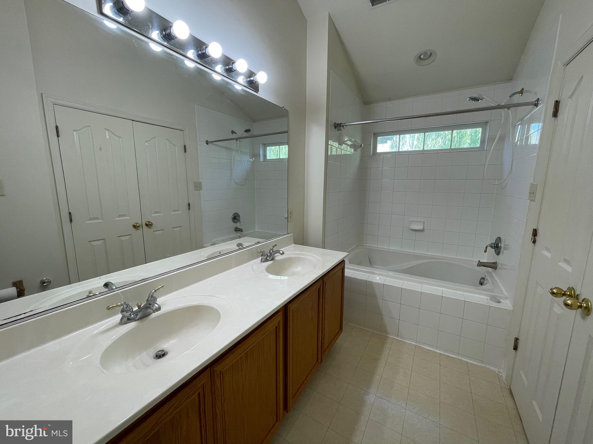 2017 Buell Drive Frederick, MD 21702 - Photo 16 of 23 a bathroom with a double vanity sink and mirror with bathtub